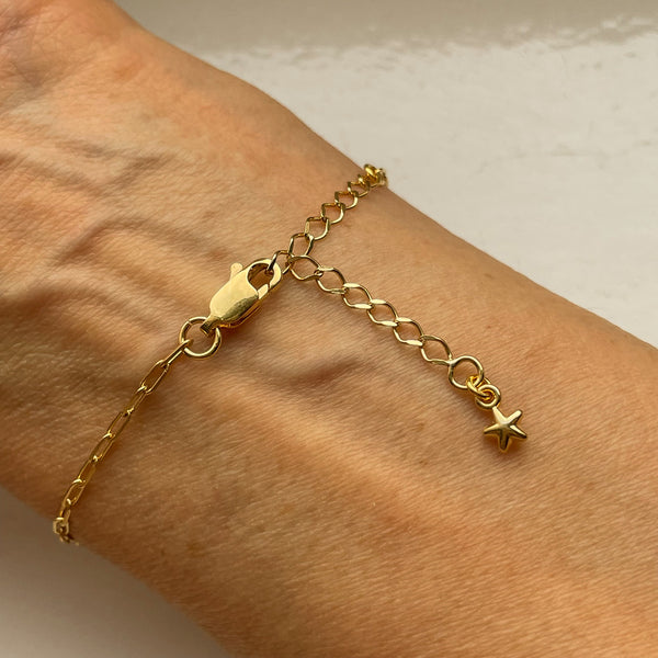 worn golden bracelet invalides